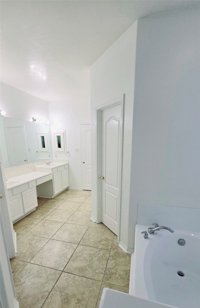 bathroom with vanity, a tub to relax in, and tile patterned flooring