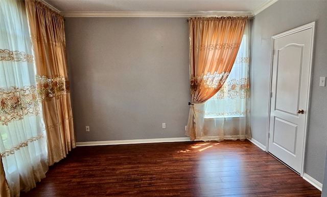 spare room with crown molding and dark hardwood / wood-style flooring