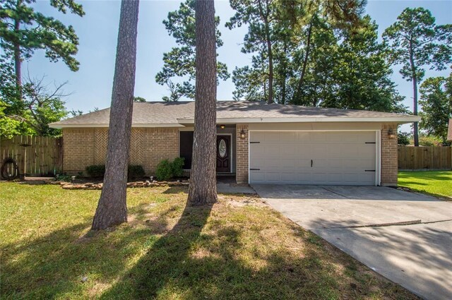 single story home with a garage and a front yard