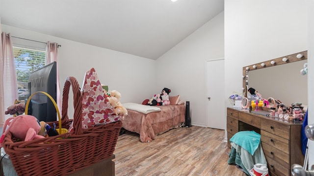 bedroom featuring vaulted ceiling and wood-type flooring