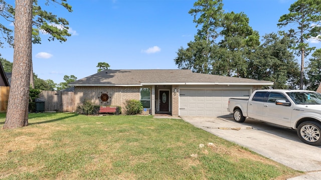 ranch-style house featuring a front yard and a garage