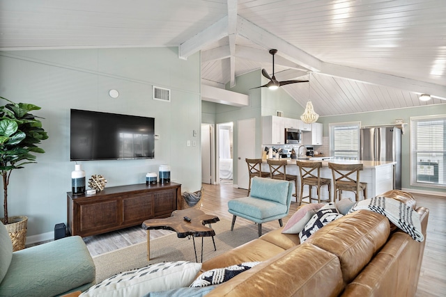 living room featuring beam ceiling, ceiling fan, light hardwood / wood-style floors, and sink