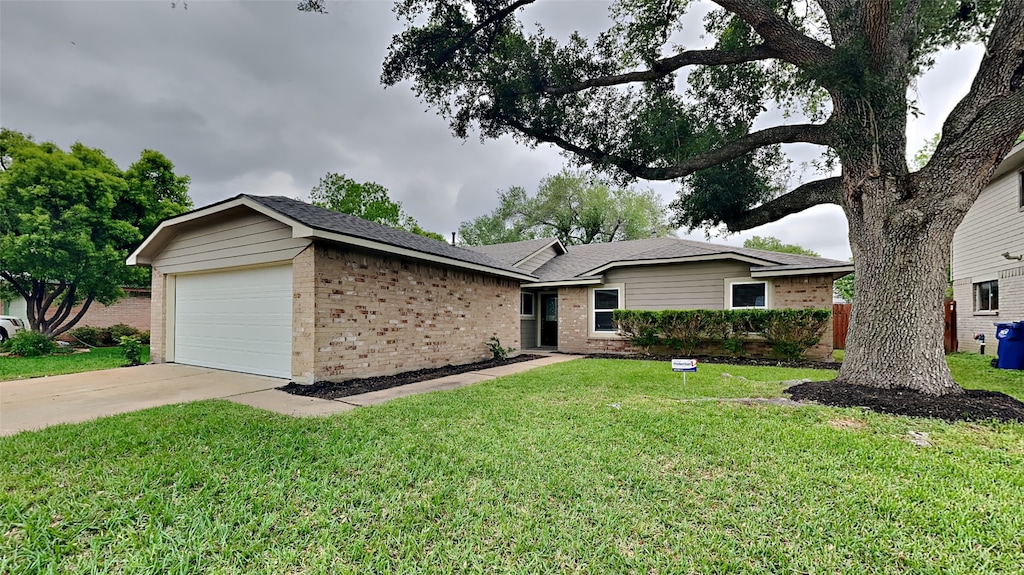 single story home with a front yard and a garage