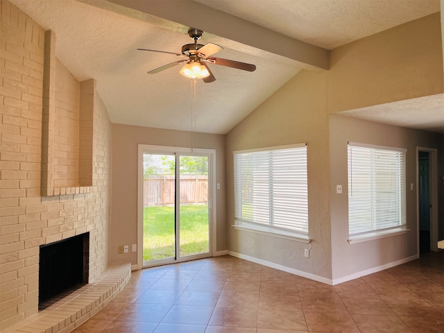 unfurnished living room featuring a brick fireplace, ceiling fan, a textured ceiling, lofted ceiling with beams, and light tile floors