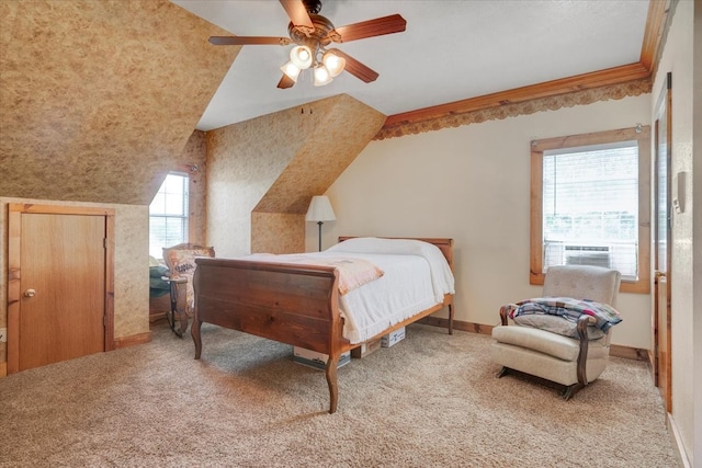 carpeted bedroom with vaulted ceiling, ceiling fan, and crown molding