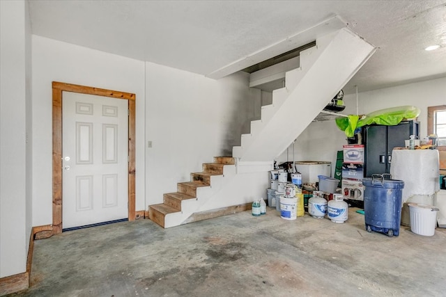 interior space featuring a textured ceiling and concrete floors