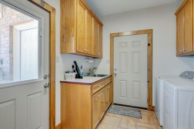 kitchen with washing machine and dryer, light tile floors, and sink