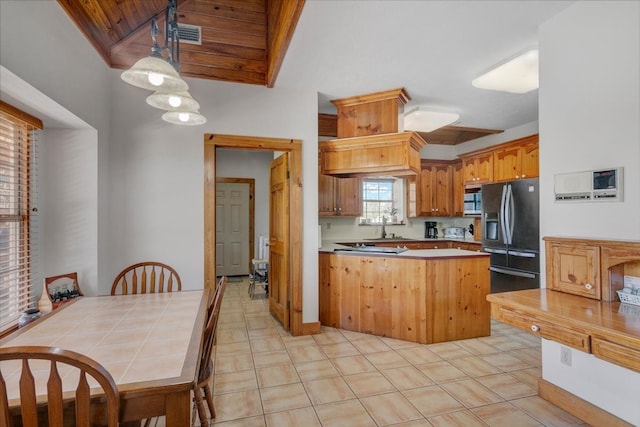 kitchen with black fridge, wood ceiling, tile countertops, pendant lighting, and light tile floors