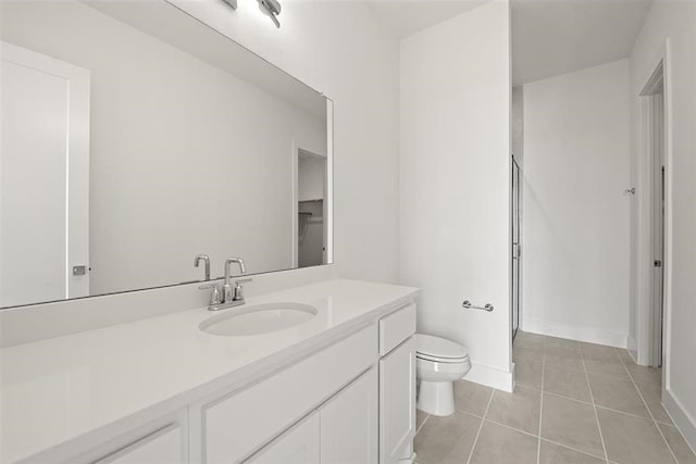 bathroom featuring vanity, toilet, an enclosed shower, and tile patterned floors