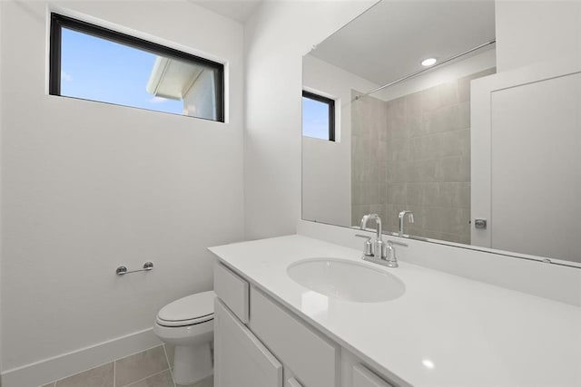 bathroom featuring vanity, toilet, tiled shower, and tile patterned floors