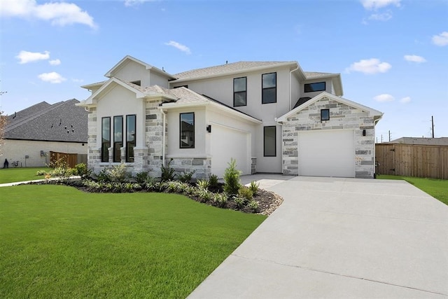 view of front of property featuring a front yard and a garage