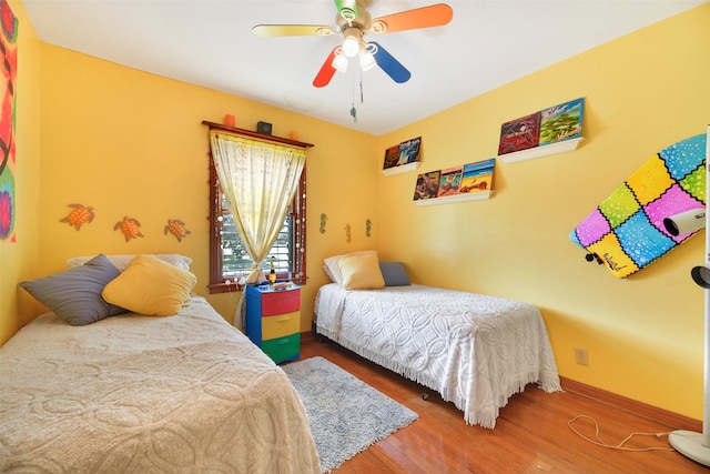 bedroom featuring dark hardwood / wood-style floors and ceiling fan