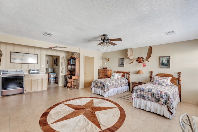 tiled bedroom featuring ceiling fan and a textured ceiling