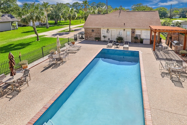 view of pool with a yard, a patio, and a pergola