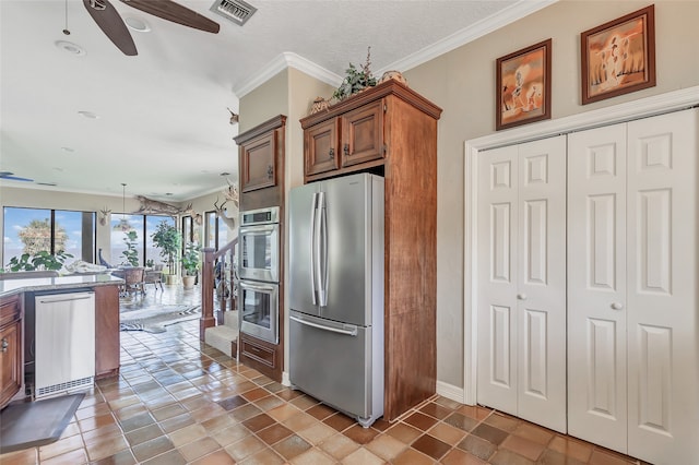 kitchen featuring appliances with stainless steel finishes, decorative light fixtures, ceiling fan, and ornamental molding