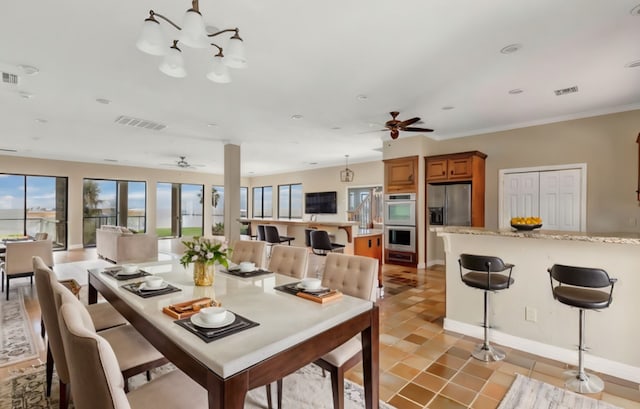 dining room featuring light tile patterned floors, ceiling fan, and crown molding