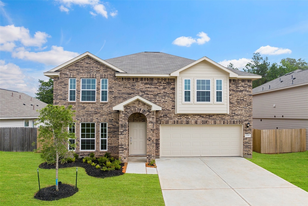 view of front of property featuring a garage and a front yard