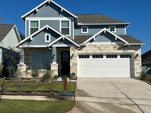 craftsman house featuring a garage and a front yard