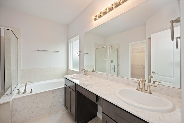 bathroom featuring independent shower and bath, tile patterned floors, and vanity