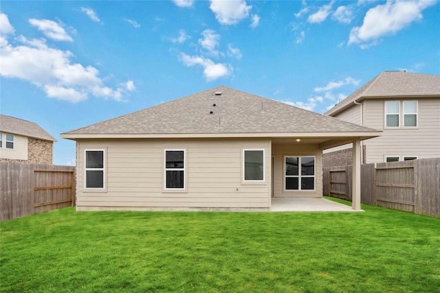 back of house with a lawn and a patio