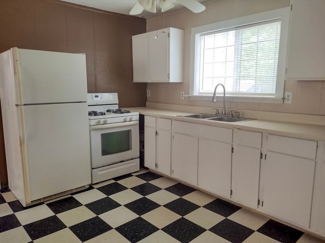 kitchen featuring light tile patterned flooring, white appliances, white cabinets, ceiling fan, and sink