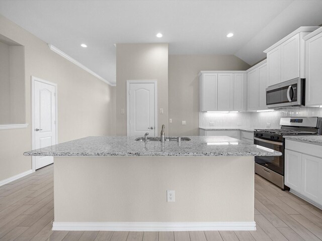 kitchen with appliances with stainless steel finishes, sink, and white cabinets