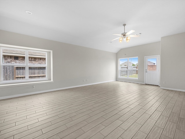 spare room featuring light wood-type flooring, ceiling fan, and vaulted ceiling