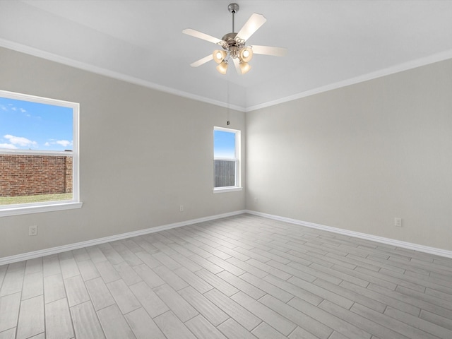 unfurnished room featuring ceiling fan, ornamental molding, wood finished floors, and baseboards