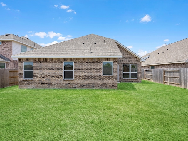 rear view of house featuring a yard