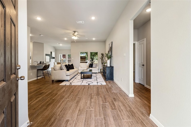 living room featuring hardwood / wood-style flooring and ceiling fan