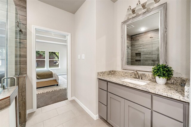 bathroom featuring tile patterned floors, an enclosed shower, and vanity