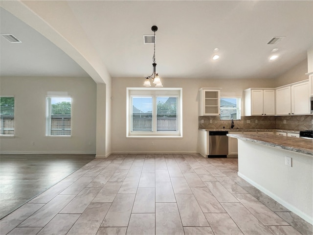 kitchen featuring appliances with stainless steel finishes, tasteful backsplash, pendant lighting, and white cabinets