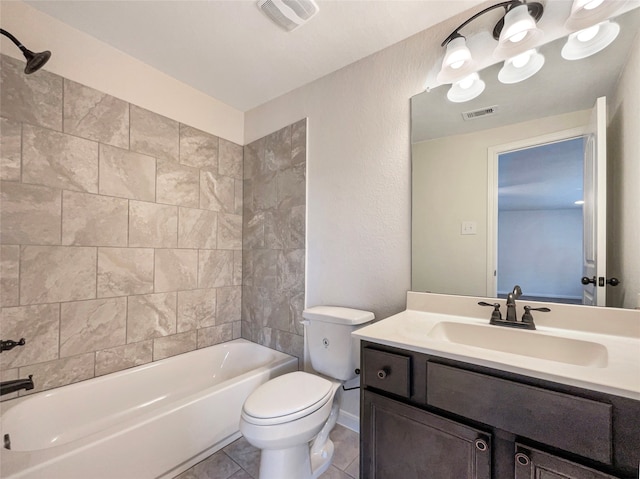 full bathroom with tiled shower / bath combo, tile floors, vanity, and toilet