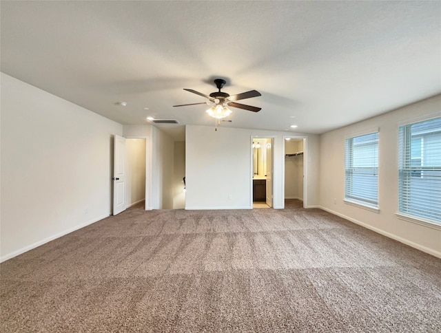 spare room with ceiling fan and carpet