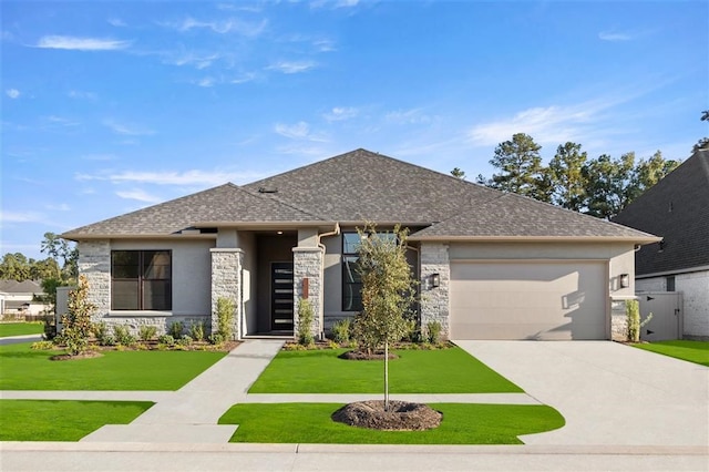 prairie-style home with a garage and a front lawn