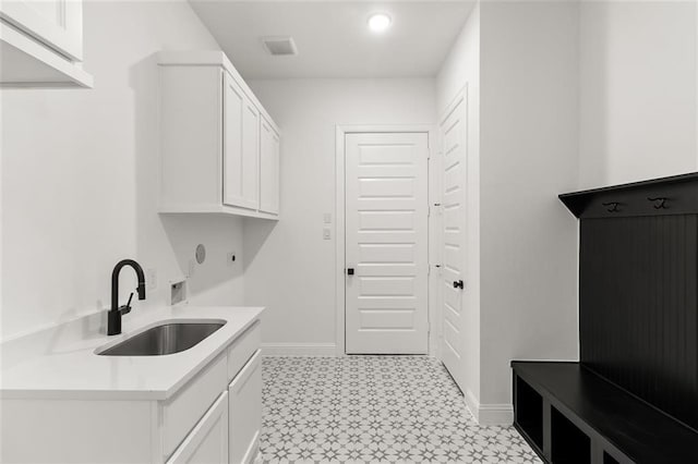 laundry room featuring sink, cabinets, and washer hookup