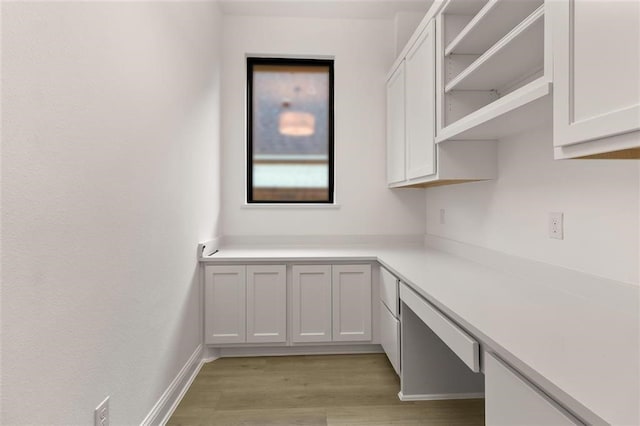 kitchen featuring white cabinets and light wood-type flooring