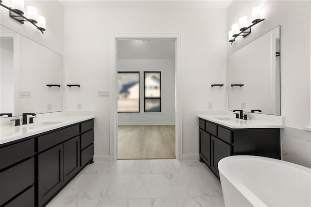 bathroom featuring a washtub, hardwood / wood-style floors, and vanity