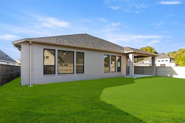 back of house with a lawn