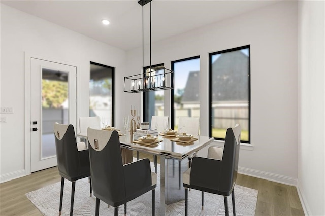 dining area featuring light hardwood / wood-style floors and an inviting chandelier