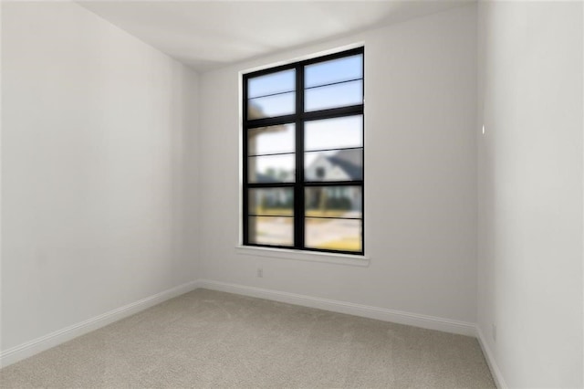 unfurnished room featuring light colored carpet and a healthy amount of sunlight