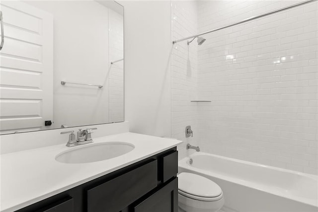 full bathroom featuring vanity, tiled shower / bath combo, and toilet