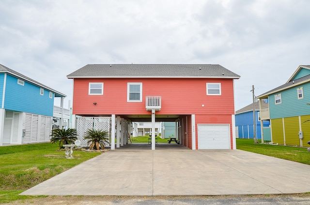 view of front of property with a garage, a carport, and a front lawn