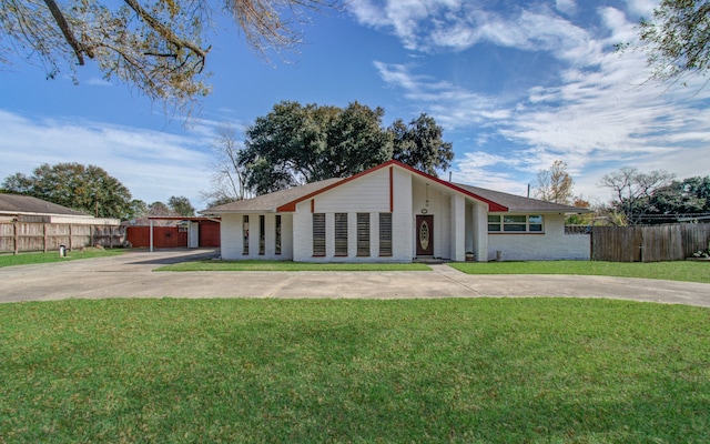 ranch-style home with a front lawn