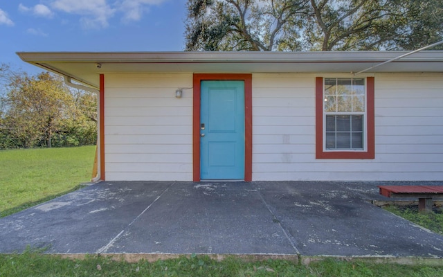 entrance to property featuring a yard