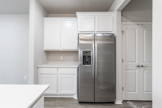 kitchen with white cabinets, hardwood / wood-style floors, and stainless steel refrigerator with ice dispenser