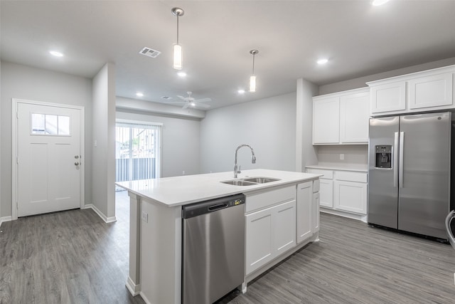 kitchen with ceiling fan, sink, light wood-type flooring, decorative light fixtures, and stainless steel appliances