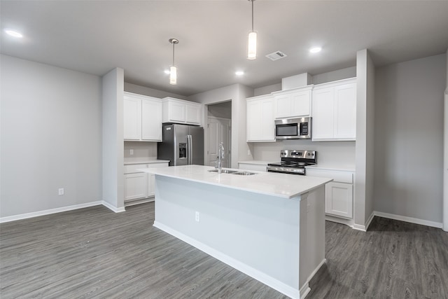 kitchen featuring stainless steel appliances, dark wood-type flooring, an island with sink, white cabinetry, and sink