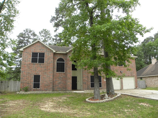 view of front of home featuring a garage and a front lawn