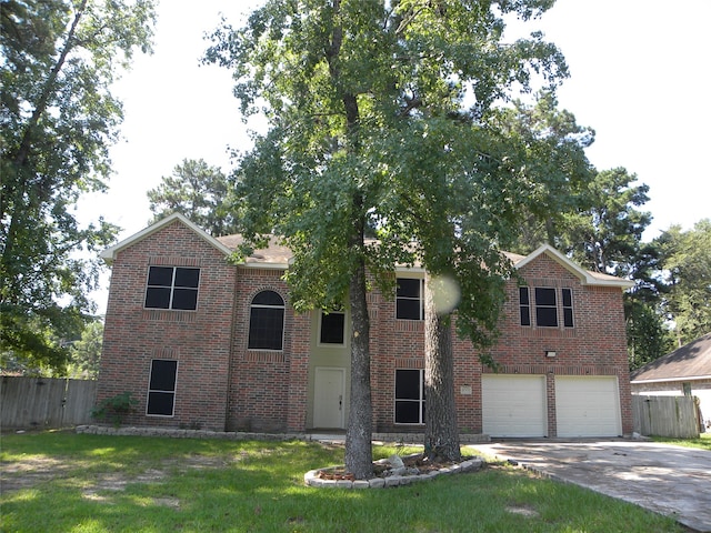 view of front of home with a garage and a front lawn